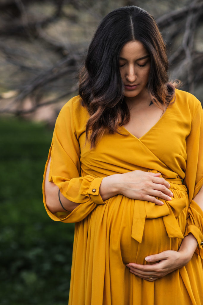 This vibrant boho maternity shoot in Mesa AZ, was straight out of a fairytale! The beautiful, lush greenery at Coon Bluff gave this shoot a dreamy vibe. Photo by Kaylene Carinna Photography.